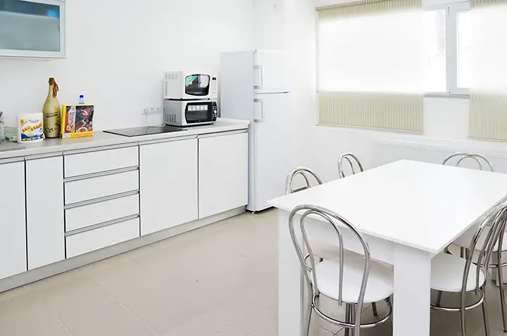 A white shopping cart filled with electrical appliances to be reviewed