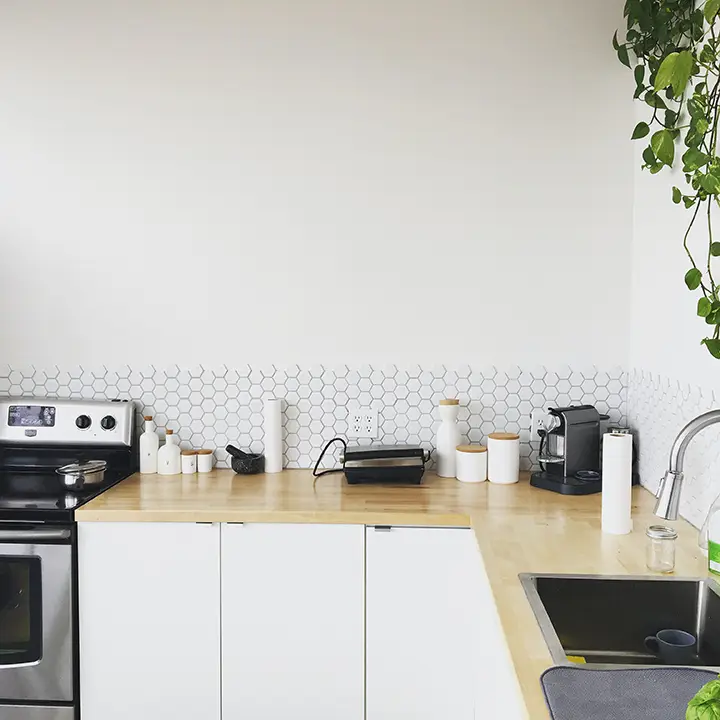 Image of a business cookery cookbook and kitchen utensils on a white kitchen counter