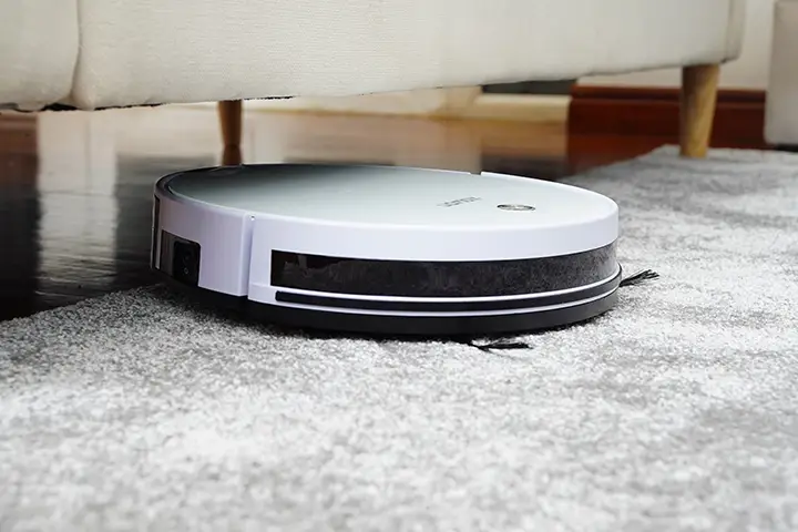 A red vintage vacuum cleaner surrounded by warning symbols